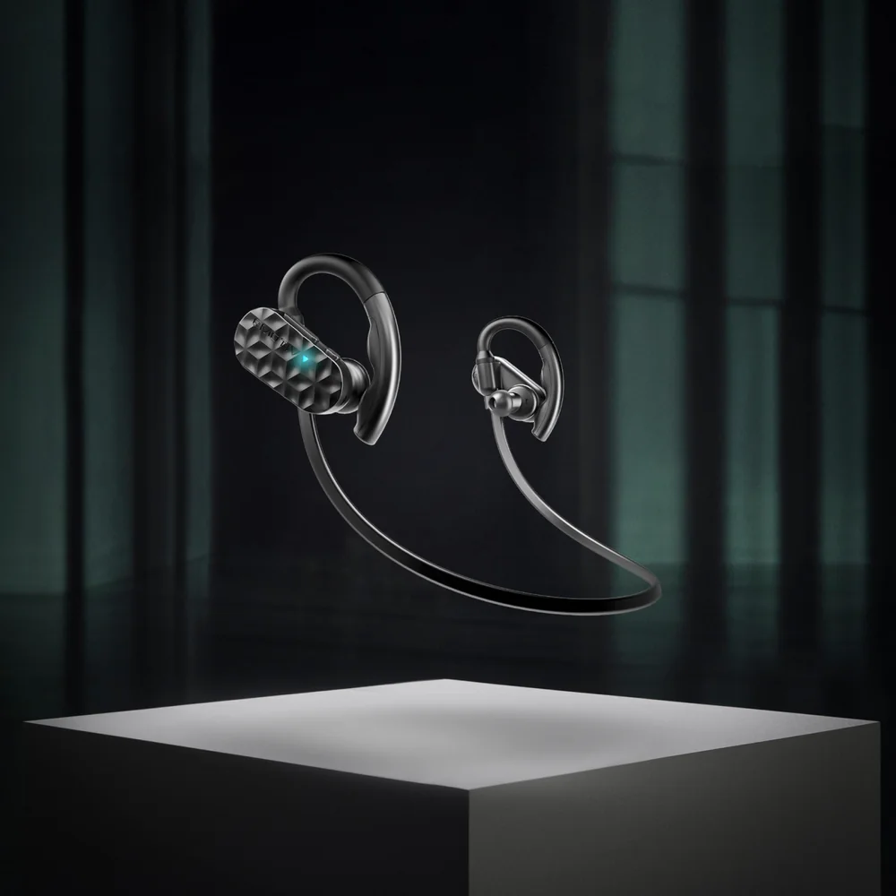 Black sport earbuds floating above a stone plinth in a dark room