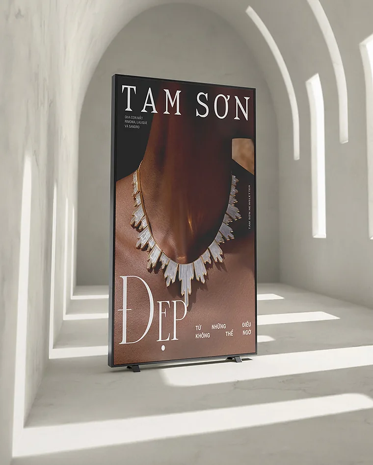 Tam Sơn jewellery poster standing in a white arched corridor