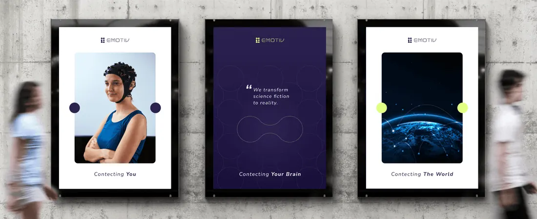 Three framed posters on a wall with passers-by